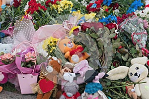 Lots of flowers and children`s toys at the place where the children died. The result of a missile attack by the Russian army