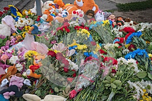 Lots of flowers and children`s toys at the place where the children died. The result of a missile attack by the Russian army