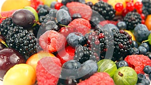 Lots of fresh different berries on a white background