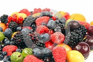 Lots of fresh different berries on a white background