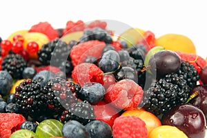 Lots of fresh different berries on a white background