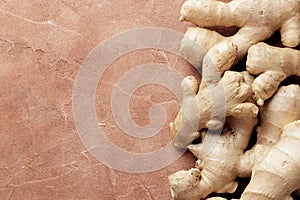 Lots of fresh ginger on a textured