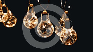 Lots Hanging Glowing Vintage Edison Light Bulbs on Black Background