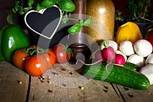 A lots of healthy vegetables on a wooden table, heart