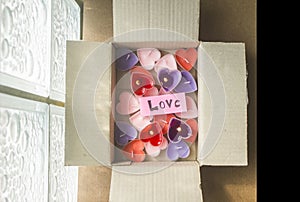 Lots of heart-shaped candles are in the parcel box on Valentine`s Day.