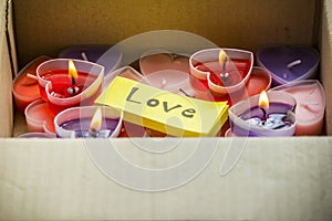Lots of heart-shaped candles are in the parcel box on Valentine`s Day.