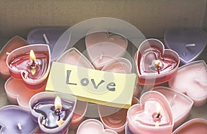 Lots of heart-shaped candles are in the parcel box on Valentine`s Day.