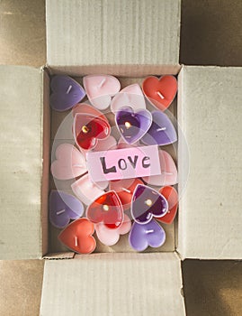 Lots of heart-shaped candles are in the parcel box on Valentine`s Day.