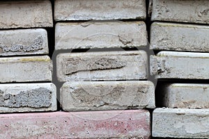 Lots of old paving tiles. Dismantled garden path. Selection focus. Shallow depth of field