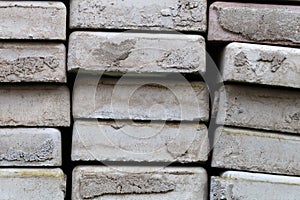 Lots of old paving tiles. Dismantled garden path. Selection focus. Shallow depth of field