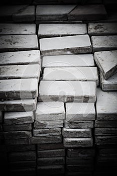 Lots of old paving tiles. Dismantled garden path. Selection focus. Shallow depth of field. Toned