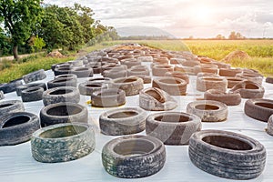 Lots of old used car tires close up on white background