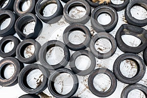 Lots of old used car tires close up on white background