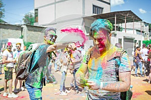 The lots of people in the color fest, colored faces of the peoples, color festival in india