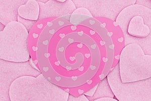 Lots of pink felt hearts with paper heart love background