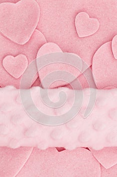 Lots of pink felt hearts with plush banner love background