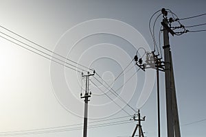 Lots of poles with wires. Electrical wires against sky. Radio communication towers.