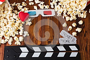 Lots popcorn, 3D-glasses, heart, movie tickets and movie clapper