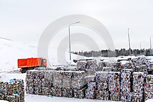 Lots of pressed paper at a waste recycling plant. Winter time. No people