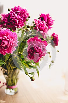 Lots of pretty and romantic flowers peonies in floral shop.