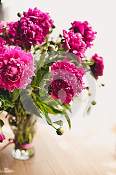 Lots of pretty and romantic flowers peonies in floral shop.