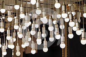 Lots of round LED lights hang from ceiling. Original lighting decor of interior. many light bulbs.