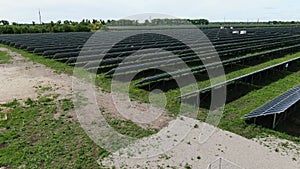 Lots of rows of the solar panels in the field on a sunny day, 4k