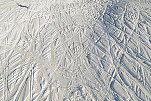 Lots ski traces at skiing resort. Snow texture. Extreme sport. Active lifestyle. Background with copy space.