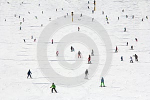 Lots of skiers and snowboarders on the slope