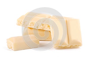 Lots slices of white chocolate isolated on white background close up