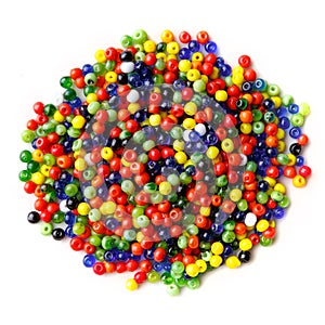 Lots of small, multi-colored glass beads, isolated on a white background