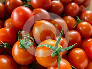 Lots of small round red fresh natural cherry tomatoes. Background, texture