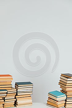 Lots of stacks of old educational books on white background university school library