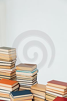 Lots of stacks of old educational books on white background university school library