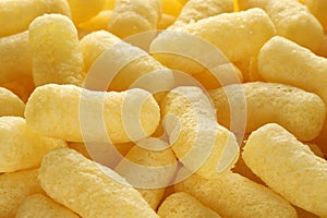 Lots of sweet corn sticks, close up. Delicious and airy treat.