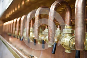 Lots of taps in brewery photo