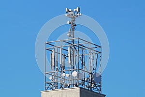 Lots of telcommunication antennas on the roof a house