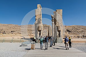 Lots tourists at the Ruins of the Gate of All Nations in the Persepolis in Shiraz, Iran. The ceremonial capital of the Achaemenid