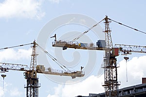 Lots of tower cranes build large residential buildings at night.