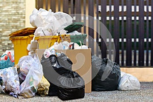 Lots waste bin recycle and garbage plastic bags at the fence home, many trash waste plastic bags front house, pollution garbage