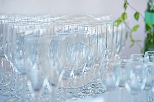 Lots of wine or champagne glasses on table. Tablewear for drink. Bar Setting. Banquet Celebration Wedding Party decoration