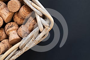 Lots of wine corks in a basket on a dark background with space for text. Vineyard, winery, restaurant, hotel, winery