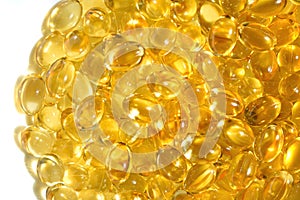 Lots of yellow capsules, golden oil fish omega 3 capsules- Omega-3 oil pils on white backgounf. Fish oil