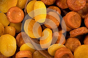 Lots of yellow and orange dried apricots fruits. View from above.