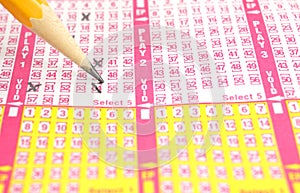 Lottery ticket being check marked