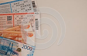 Lottery tickets and money won on a white background. Space for the inscription. Lottery ticket and Russian ruble