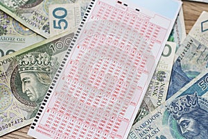 Lotto coupon lies on PLN banknotes.