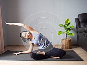 Lotus pose yoga sitting side bend asian woman home workout fitness body exercise pilates health training sport healthy lifestyle