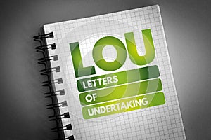 LOU - Letters Of Undertaking acronym on notepad, business concept background