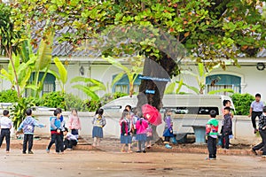 LOUANGPHABANG, LAOS - JANUARY 11, 2017: Children in the school yard. Copy space for text.